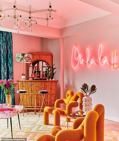 a living room filled with furniture and neon lights