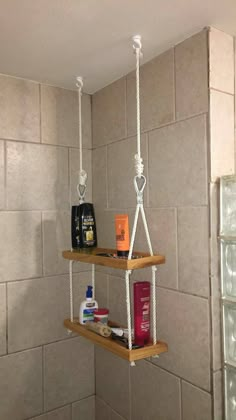 two shelves with soap, shampoo and lotion on them in a shower stall