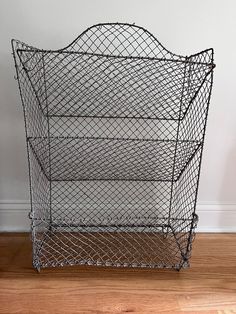 a metal wire basket on the floor