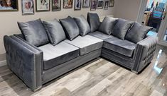 a gray couch sitting on top of a hard wood floor