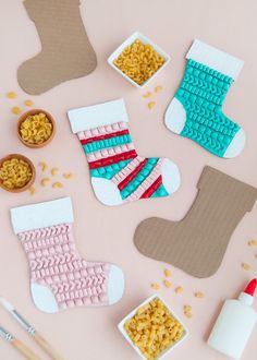 some crafting supplies are laid out on a pink surface, including socks and cereal