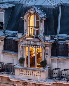 an ornate building with windows and balconies lit up at night