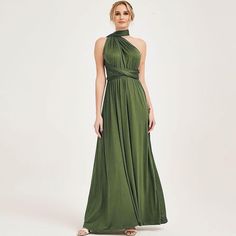 a woman wearing a green dress with a halter neckline and pleaed skirt