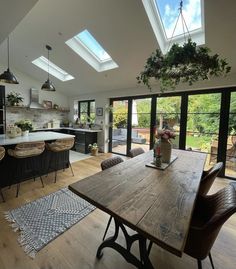 an open kitchen and dining room with skylights