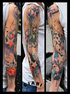 the arm is covered with many different colored tattoos on it's sides and arms