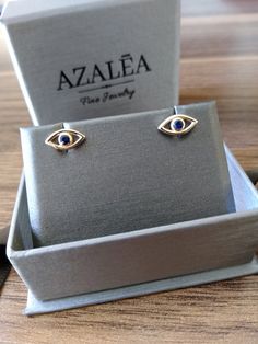 "These 14k gold evil eye stud earrings are set with a sparkling \"iris\" sapphire. Ideal for everyday wear. ** Purchase a single stud for 1/2 the price M A T E R I A L & L E N G T H Available in 14k Yellow Gold, 14k Rose Gold, 14k White Gold Sapphire: 0.07 ct. C U R R E N T ∙ T U R N A R O U N D Processing Time: 1-2 weeks Within United States: approx. 3-5 biz days (faster shipping available) Other Countries: approx. 1-3 weeks Do you need urgent, last minute shipping? Send us a message and we 14k Gold Evil Eye Jewelry Gift, Yellow Gold Evil Eye Jewelry For Anniversary, Fine Jewelry Earrings With Diamond Eyes As Gift, Gold Evil Eye Earrings As Gift, Elegant Evil Eye Earrings As A Gift, Elegant Evil Eye Earrings For Gift, Gold Plated Evil Eye Elegant Earrings, Elegant Gold Plated Evil Eye Earrings, Elegant Gold-plated Evil Eye Earrings