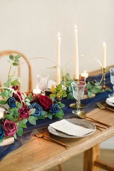 the table is set with flowers and candles