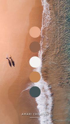 two people parasailing on the beach with their surfboards in front of them