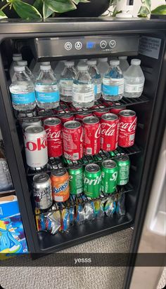 a mini fridge filled with lots of soda and water