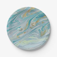 a blue and gold marble plate on a white background