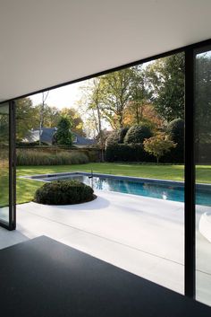 an empty pool in the middle of a large backyard