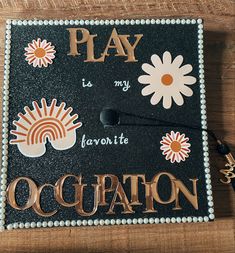 a graduation cap that says play is my favorite ocquation with flowers on it