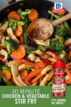 chicken and vegetable stir fry in a pan with broccoli, carrots, peppers and mushrooms