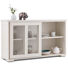 an elephant figurine is on top of a white cabinet with glass doors and shelves