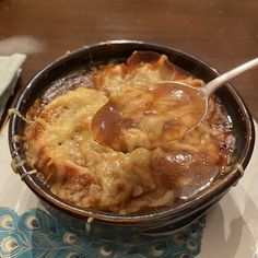 a spoon with some food in it on a plate