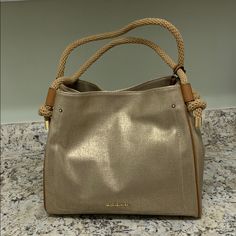 Brand New Gold And Tan Handbag. Very Neutral And Perfect For All Seasons! Straps Can Go Over The Shoulder. 13” Wide 11” High 5 1/2 Inches Deep Gold Bucket Shoulder Bag With Top Carry Handle, Gold Bucket Bag With Top Carry Handle, Gold Shoulder Bucket Bag With Top Carry Handle, Gold Top Handle Shoulder Bag With Leather Handles, Gold Top Handle Bag With Leather Handles, Gold Satchel Bucket Bag With Gold-tone Hardware, Gold Bucket Bag With Gold-tone Hardware Satchel, Gold Bucket Bag With Leather Handles For Daily Use, Gold Bucket Bag With Leather Handles