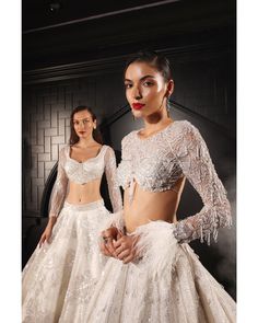 White Crystals Flared Lehenga Set - Bora Honey's Elevate your bridal allure with the Orave lehenga ensemble, a vision of purity and grace. The mesmerizing trail adds a touch of regality, while the zero neck blouse, adorned with Swarovski crystals, feathers, and sequins, encapsulates the perfect blend of modern sophistication and timeless charm. Paired with an enchanting cape, this pure white tulle satin creation promises to make your special moments radiate with unparalleled elegance. Included i Lehenga With Trail, Lehenga Outfits, Wedding Bride Dress, Indian Bridal Couture, Flared Lehenga, Modern Bridal Gowns, Hand Embroidery Work, Bridal Lengha, Indian Wedding Bride