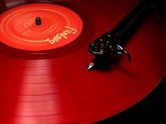 a red record player with an orange disc