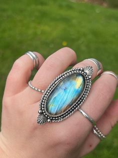 Measurements: 5.5cm X 2.5cm Weight: .81oz  Size: 8.25 (fits like an 8)  Stone: Labradorite  Ring Band: 10 gauge half round stacked triple shank.  Thank you for choosing High Peak Silver for your jewelry needs. I hope you allow my wearable art to bring a smile to your face day after day, year after year. Let them dazzle you and add some flare to everyday looks. Here are some commonly asked questions and policies. High Peak Silver is a one women operation. I do everything from the ordering/designing/creating/photography/pricing/website/customer service/social media/shipping and everything in-between. Proper care: Sterling silver is sensitive, in order to best care for you sterling silver, make sure to take it off before swimming in chlorine or salt water, avoid contact with perfumes and loti Band Fits, Photography Pricing, Labradorite Ring, Ring Band, Wide Bands, Jewelry Projects, Statement Ring, Rings Statement, Wearable Art