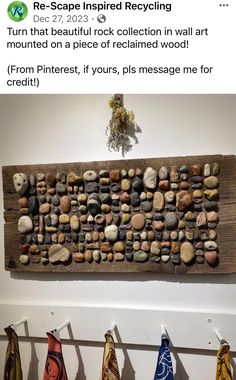 a wooden sign with rocks on it hanging from the wall next to some towels and other items