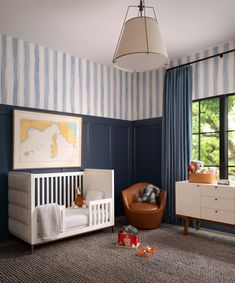 a baby's room with blue and white striped walls