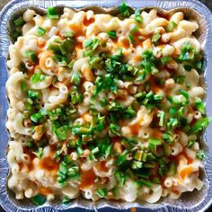 macaroni and cheese with green onions in a glass dish