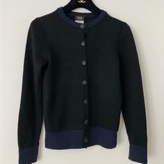 100% Authentic Chanel Uniform Cardigan Size Xs Black/Navy Good Condition Luxury Black Sweater With Button Closure, Luxury Black Cardigan With Button Closure, Designer Black Cardigan With Button Closure, Designer Black Workwear Sweater, Elegant Navy Winter Cardigan, Elegant Navy Long Sleeve Cardigan, Luxury Black Cardigan For Formal Occasions, Luxury Black Formal Cardigan, Designer Black Long Sleeve Cardigan