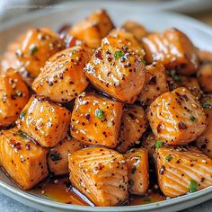 a white plate topped with tofu covered in sauce