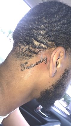 a close up of a person with a tattoo on their head and the word tranquility written in cursive writing