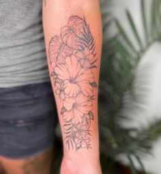 a person with a flower tattoo on their arm