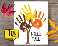 a card with the words hello fall written on it next to autumn leaves and an orange leaf