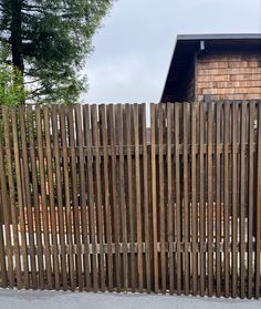 a wooden fence next to a building