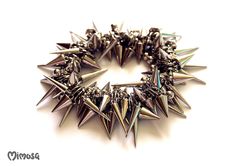 "Gothic Bracelet, Punk Spike Bracelet, Silver Spike Bracelet, Punk Rock Bracelet, Gothic Jewelry, Stud Punk Rock Bracelet, Goth Stud Bracelet, Thorn Bracelet, Unisex Punk Bracelet, Unisex Gothic Jewelry Chunky punk rock bracelet made of plastic silver spikes and beads. The beads are strung on elastic silicone cord.  Choose your wrist size with the drop-down menu. 5.5\" - 14 cm. 6\" - 15.2 cm. 6.5\" - 16.5 cm. 7\" - 17.8 cm. 7.5\" - 19.1 cm. 8\" - 20.3 cm. 8.5\" - 21.6 cm. 9\" - 22.9 cm. ♥ Unique Silver Punk Bracelets With Spikes, Rocker Style Spike Bracelets For Festivals, Metal Studs Bracelets For Party, Metal Bracelets With Studs For Party, Silver Spiked Bracelets For Parties, Metal Party Bracelets With Studs, Party Bracelets With Metal Studs, Gothic Metal Bracelets With Spikes, Rock Style Metal Bracelet With Spikes