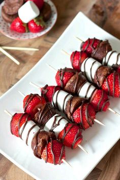 strawberry brownie kebabs with chocolate drizzled on them