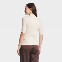 Take your casual looks to the next level with this Ribbed Short-Sleeve Mock Turtleneck T-Shirt from A New Day™. The short-sleeve tee is cut from midweight fabric with added spandex for comfortable wear from day to night and season to season, while the 2 x 2 rib-knit construction adds a touch of texture. Tailored in a flattering fitted silhouette, the short-sleeve tee with a mock turtleneck is easy to dress up or down for a variety of occasions. A New Day™: Style that goes wherever you do. Ribbed High Neck Top For Work, Relaxed Fit High Neck Tops, Ribbed Beige Tops For Workwear, Beige Ribbed Tops For Workwear, Ribbed Beige Workwear Tops, Beige Ribbed Tops For Work, Beige Tops With Ribbed Neckline For Work, Spring High Neck Top With Ribbed Neckline, Beige Ribbed Neckline Top For Work