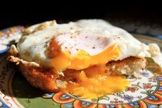 an egg is sitting on top of some bread