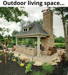 an outdoor fireplace and grill in the middle of a garden