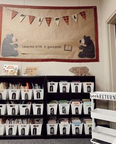 the bookshelves are filled with children's books in front of a banner