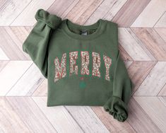 Merry Sweatshirt, Christmas Sweater, Merry Christmas Crewneck, Varsity Style Christmas Sweater, Womens Christmas Tops, Holiday Apparel This crewneck sweatshirt is pure comfort. Made from a soft cotton/poly blend with no itchy side seams, this is sure to become a staple. SIZE AND FIT: Your sweatshirt design will be printed on a high-quality, soft and comfortable unisex sweatshirt. Sizes run true to size, which takes the guesswork out of ordering; if you like your sweatshirts loose or oversized, y Christmas Gifts For Mother, Merry Sweatshirt, Womens Christmas Tops, Gifts For Mother, V Neck Shirts, Womens Christmas, Holiday Apparel, Varsity Style, Mother Christmas Gifts