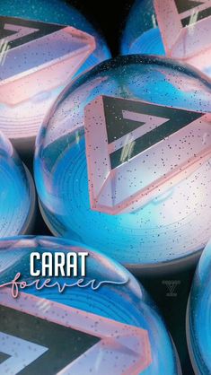 some blue and pink balls with the word carat written on them in white letters