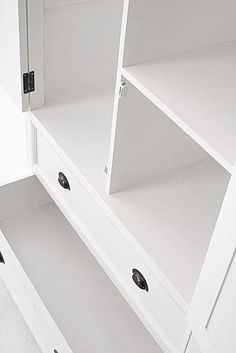 a white cabinet with two doors and drawers