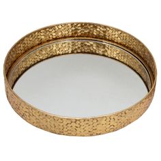 two round metal trays with gold speckles on the rim, one holding a mirror