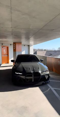 a black car parked in a parking garage