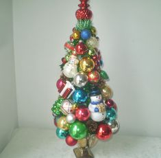 a small christmas tree made out of ornaments