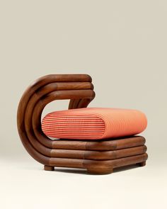 an orange cushion on top of a wooden chair