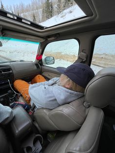 a man sleeping in the back seat of a truck