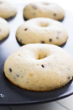 chocolate chip doughnuts in a muffin tin ready to be baked into the oven