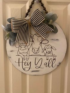 a door hanger with a pig and dog on it that says hey y'all