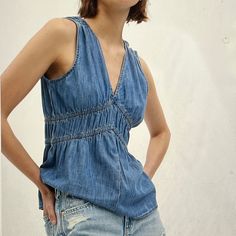 Gap 100% Organic Cotton Denim Top Size L Smooth Woven Denim Top V Neck, Sleveless, Elasticized Detailing At Waist Flared Bottom, A-Line Silhouette With A Relaxed Fit Hits At The Hip Relaxed Fit Blue Denim Top For Summer, Blue Relaxed Fit Denim Top For Summer, Indigo Cotton Top For Spring, Casual Denim Blue Tops For Summer, Casual Denim Blue Summer Top, Blue Chambray Denim Top For Summer, Casual Everyday Denim Blue Top, Casual Relaxed Fit Denim Top Made Of Tencel, Indigo Denim Tops With Relaxed Fit