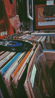 an old record player sits on top of records in a room full of other records